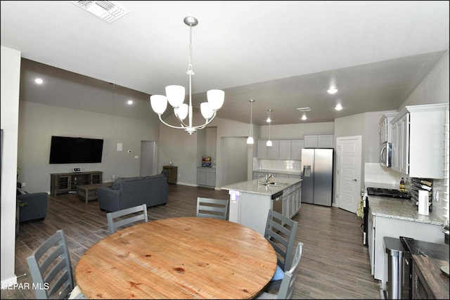 929 Pecos River Dr, El Paso, TX 79932 - dining space with a chandelier and dark wood-style flooring