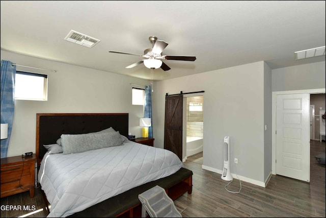 929 Pecos River Dr, El Paso, TX 79932 - bedroom with a barn door, wood finished floors, ceiling fan, and ensuite bathroom
