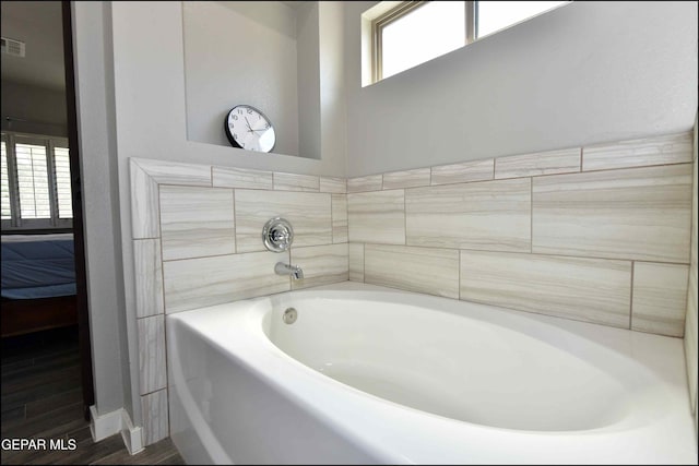 929 Pecos River Dr, El Paso, TX 79932 - full bathroom featuring a garden tub and wood finished floors