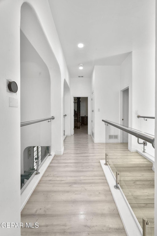 12247 Chisholm Pass Dr, El Paso, TX 79936 - hall with wood finished floors, arched walkways, and recessed lighting