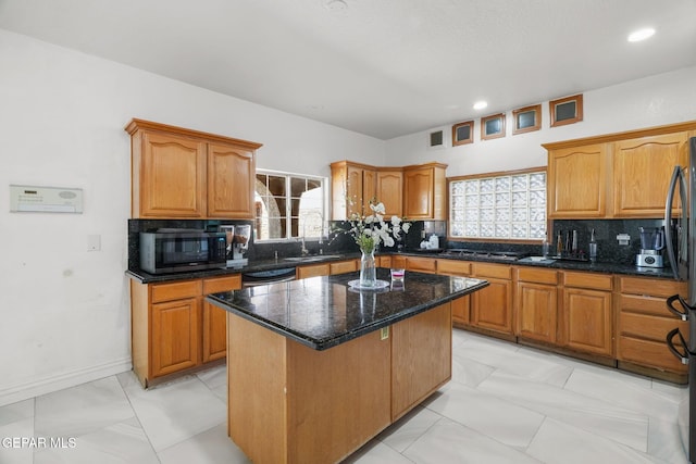 12247 Chisholm Pass Dr, El Paso, TX 79936 - kitchen with black microwave, light marble finish flooring, a kitchen island, tasteful backsplash, and recessed lighting