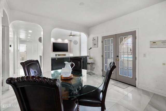 12247 Chisholm Pass Dr, El Paso, TX 79936 - dining area with french doors, a ceiling fan, and arched walkways