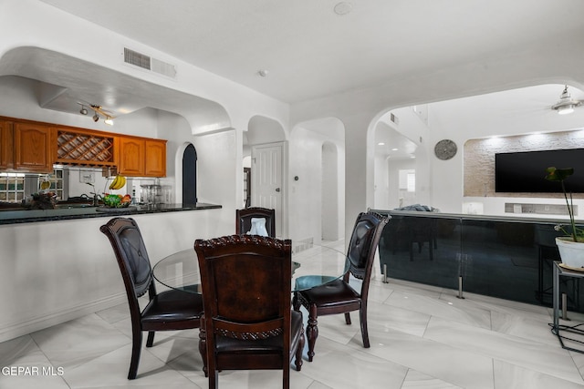 12247 Chisholm Pass Dr, El Paso, TX 79936 - dining space featuring arched walkways and light marble finish floors