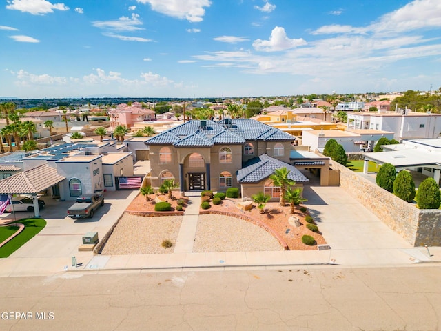 12247 Chisholm Pass Dr, El Paso, TX 79936 - mediterranean / spanish-style house with driveway, a residential view, stucco siding, and a tiled roof