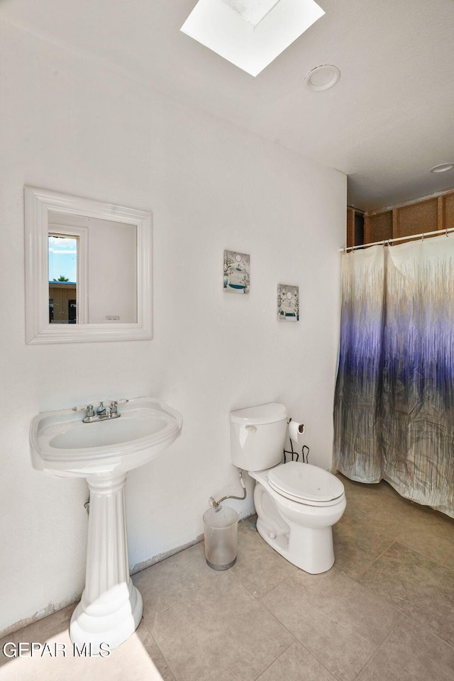 12247 Chisholm Pass Dr, El Paso, TX 79936 - bathroom with a skylight and a shower with shower curtain