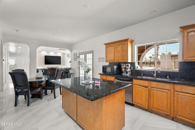 12247 Chisholm Pass Dr, El Paso, TX 79936 - kitchen featuring stainless steel dishwasher, black microwave, tasteful backsplash, a center island, and dark stone counters