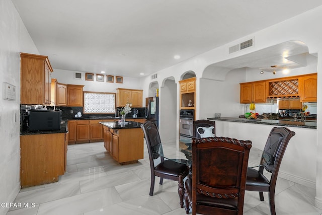 12247 Chisholm Pass Dr, El Paso, TX 79936 - dining area featuring arched walkways, light marble finish flooring, and recessed lighting