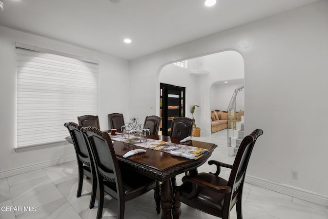 12247 Chisholm Pass Dr, El Paso, TX 79936 - dining space featuring arched walkways, light marble finish flooring, and recessed lighting