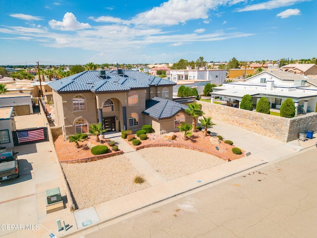 12247 Chisholm Pass Dr, El Paso, TX 79936 - mediterranean / spanish house featuring stucco siding, a tile roof, a residential view, and a gate