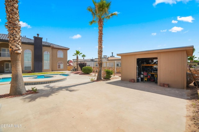 12247 Chisholm Pass Dr, El Paso, TX 79936 - exterior space with an in-ground hot tub, a patio area, and an outdoor structure