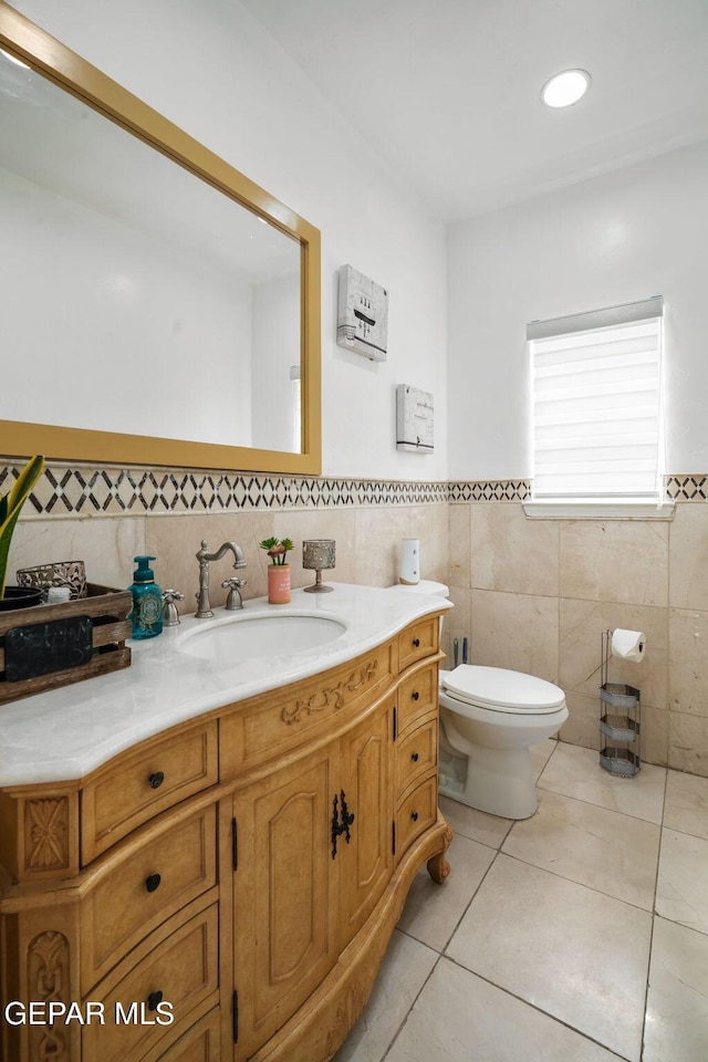 12247 Chisholm Pass Dr, El Paso, TX 79936 - bathroom featuring tile walls, vanity, tile patterned floors, and a wainscoted wall