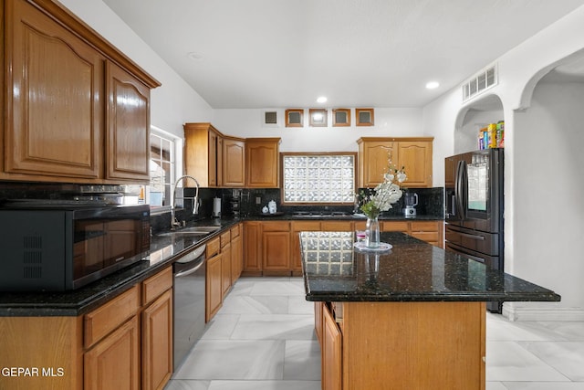 12247 Chisholm Pass Dr, El Paso, TX 79936 - kitchen featuring black microwave, fridge with ice dispenser, stainless steel dishwasher, light marble finish floors, and a kitchen island