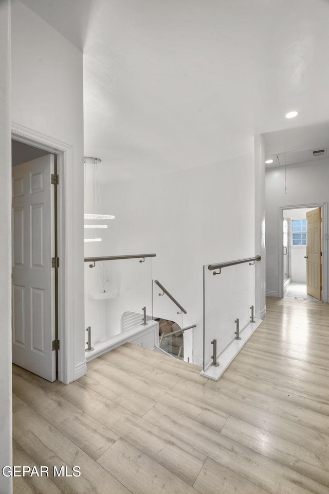 12247 Chisholm Pass Dr, El Paso, TX 79936 - hall with attic access, wood finished floors, and recessed lighting