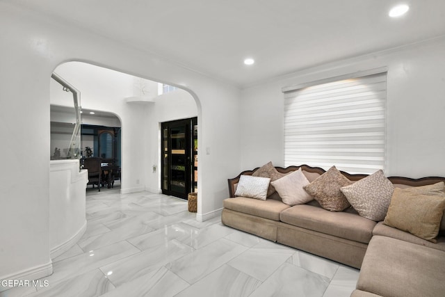 12247 Chisholm Pass Dr, El Paso, TX 79936 - living room featuring arched walkways, recessed lighting, light marble finish flooring, and ornamental molding