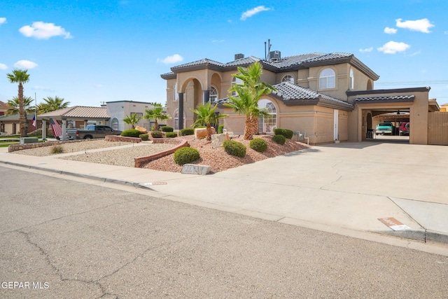 12247 Chisholm Pass Dr, El Paso, TX 79936 - mediterranean / spanish home featuring stucco siding, concrete driveway, and a tile roof