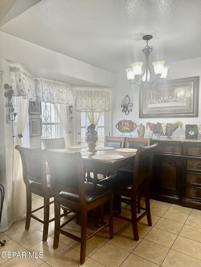 12036 Valley Quail Dr, El Paso, TX 79936 - dining room with light tile patterned floors, a chandelier, and a textured ceiling