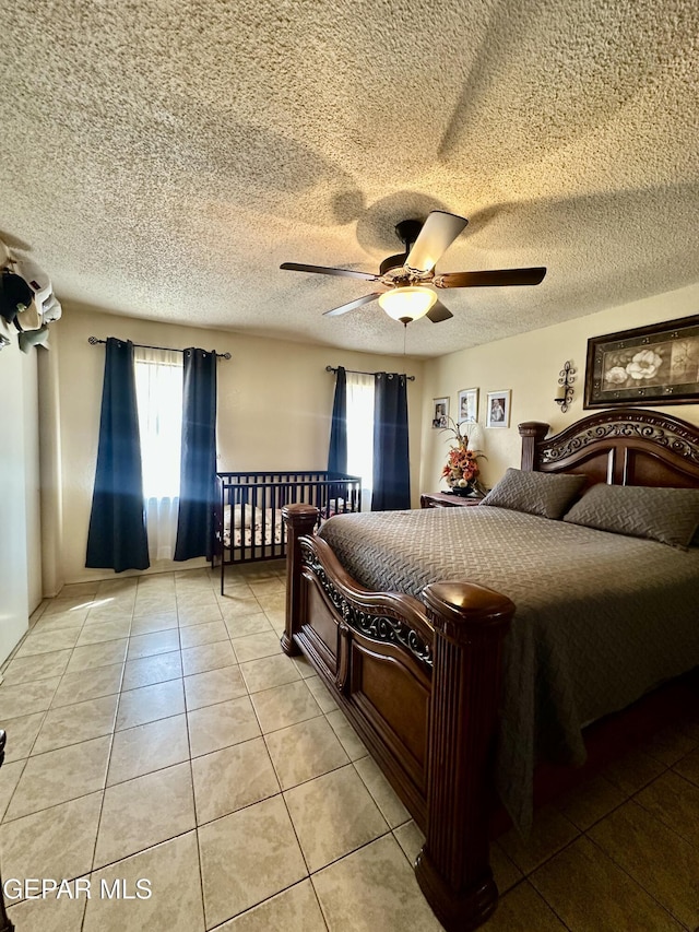 12036 Valley Quail Dr, El Paso, TX 79936 - bedroom with light tile patterned flooring, ceiling fan, and a textured ceiling