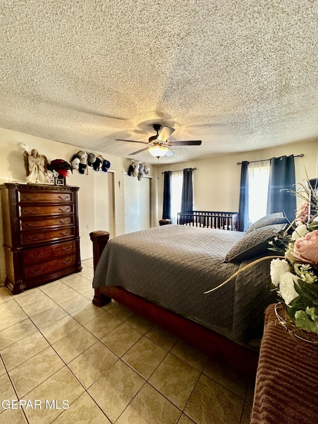 12036 Valley Quail Dr, El Paso, TX 79936 - bedroom with ceiling fan, light tile patterned floors, and a textured ceiling