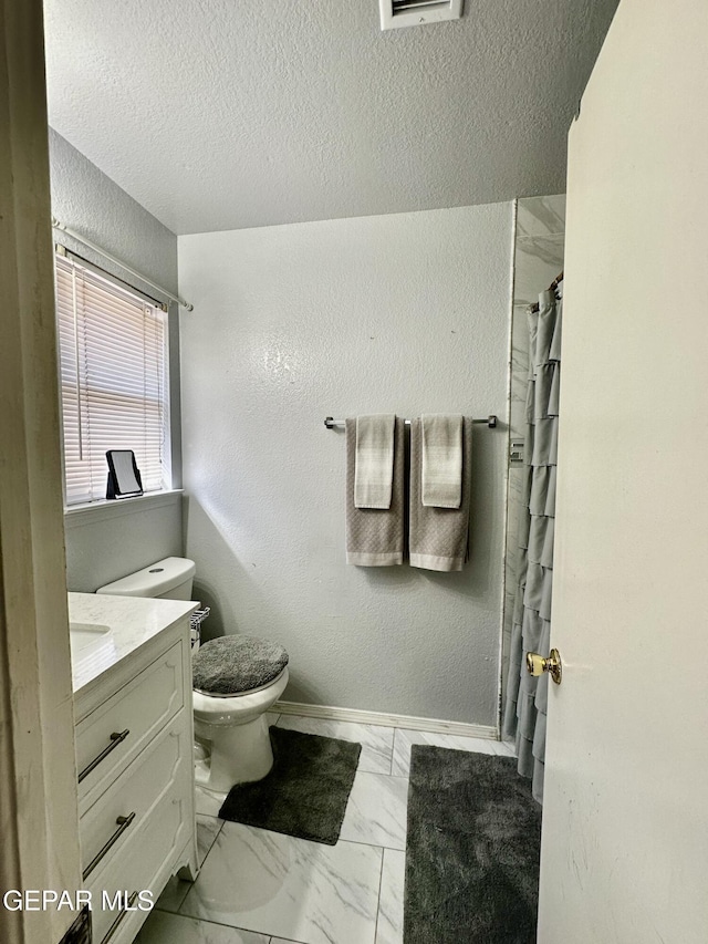 12036 Valley Quail Dr, El Paso, TX 79936 - full bath with vanity, marble finish flooring, a textured ceiling, and a shower with curtain