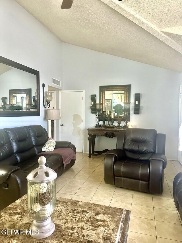 12036 Valley Quail Dr, El Paso, TX 79936 - living room featuring lofted ceiling, a textured ceiling, light tile patterned floors, and electric panel