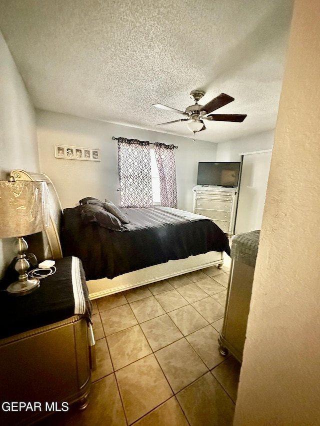 12036 Valley Quail Dr, El Paso, TX 79936 - tiled bedroom with a textured ceiling and a ceiling fan