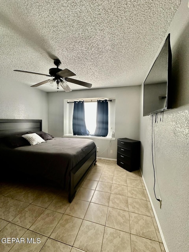 12036 Valley Quail Dr, El Paso, TX 79936 - bedroom featuring a textured ceiling, light tile patterned flooring, and a ceiling fan