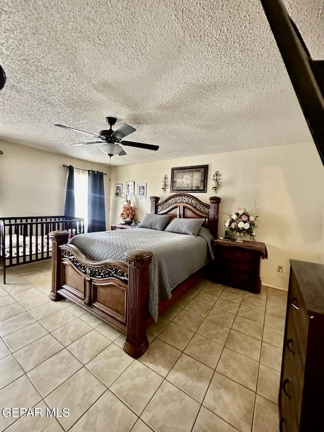 12036 Valley Quail Dr, El Paso, TX 79936 - bedroom featuring light tile patterned flooring, a textured ceiling, and ceiling fan