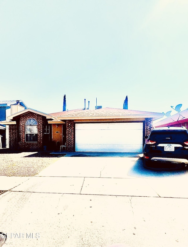 12036 Valley Quail Dr, El Paso, TX 79936 - single story home with an attached garage, concrete driveway, and brick siding