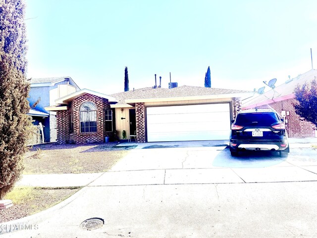 12036 Valley Quail Dr, El Paso, TX 79936 - ranch-style house featuring concrete driveway, a garage, and brick siding