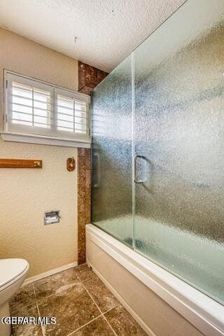 1944 Ratner Cir, El Paso, TX 79936 - bathroom with bath / shower combo with glass door, tile patterned flooring, and a textured ceiling