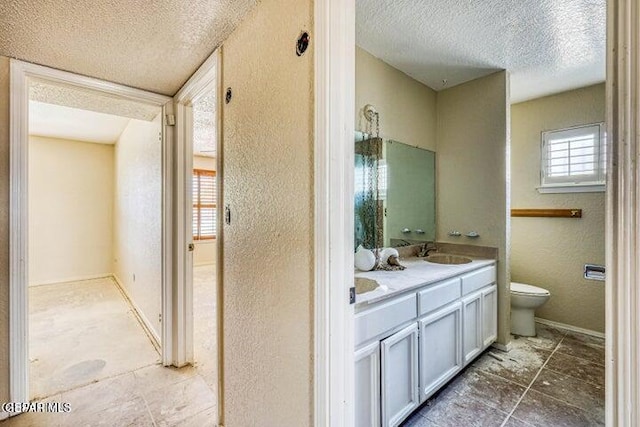 1944 Ratner Cir, El Paso, TX 79936 - bathroom with a textured ceiling, a textured wall, and double vanity