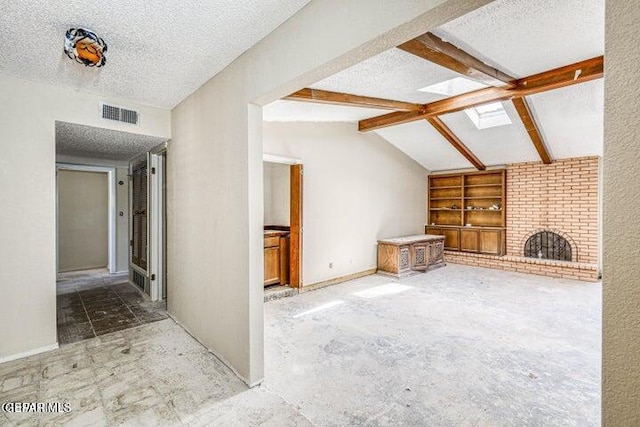 1944 Ratner Cir, El Paso, TX 79936 - unfurnished living room with a textured ceiling, a skylight, and built in features