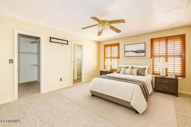 1944 Ratner Cir, El Paso, TX 79936 - bedroom featuring light colored carpet, a spacious closet, ceiling fan, and a textured ceiling