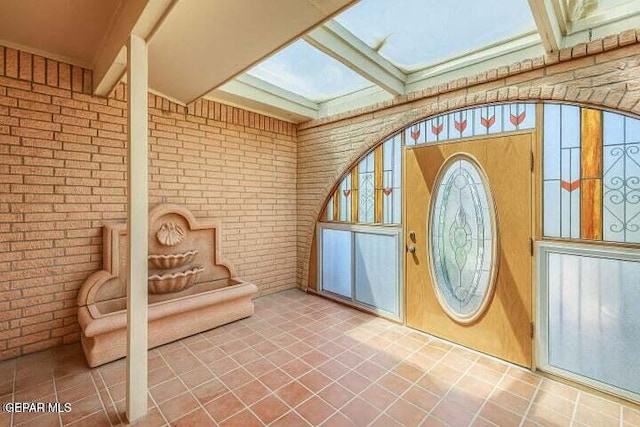1944 Ratner Cir, El Paso, TX 79936 - entrance foyer with brick wall and tile patterned floors