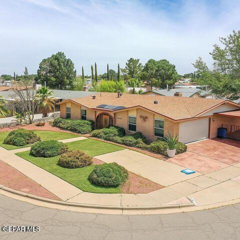 1944 Ratner Cir, El Paso, TX 79936 - ranch-style home featuring a garage, concrete driveway, a front lawn, and brick siding