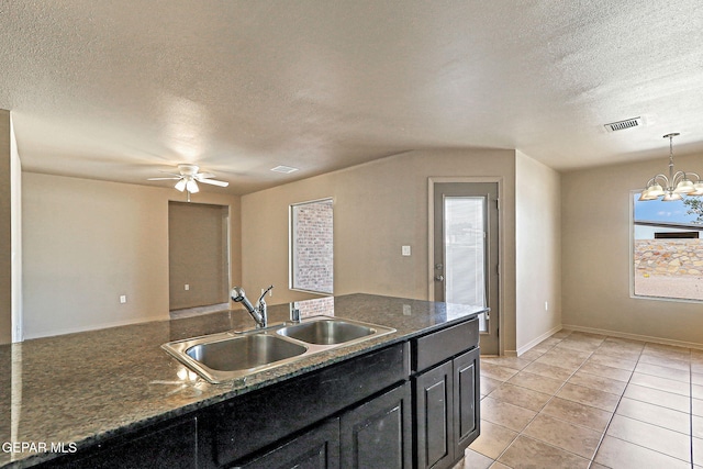 708 Cora Ruecker, El Paso, TX 79928 - kitchen featuring a textured ceiling, ceiling fan, dark cabinetry, decorative light fixtures, and a chandelier