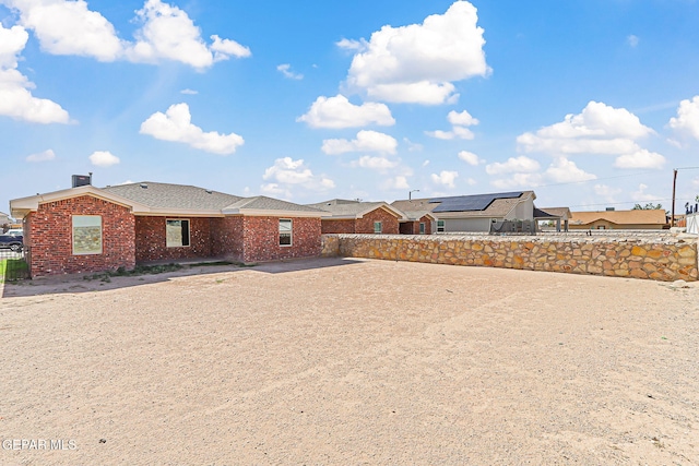 708 Cora Ruecker, El Paso, TX 79928 - view of front of property featuring brick siding, a fenced backyard, and roof with shingles