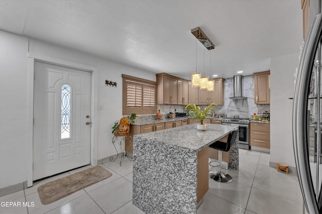 11749 Socorro Rd, Socorro, TX 79927 - kitchen with stainless steel appliances, wall chimney range hood, a center island, backsplash, and a chandelier