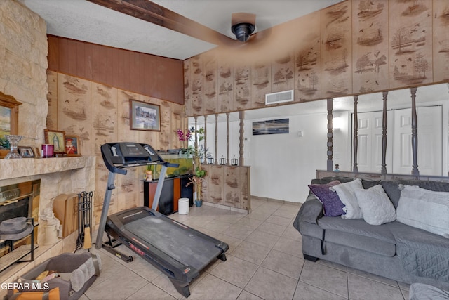 11749 Socorro Rd, Socorro, TX 79927 - exercise area with light tile patterned flooring, wood walls, and ceiling fan