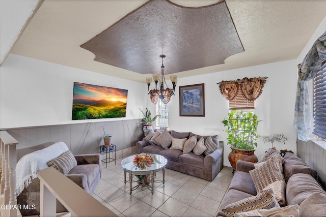 11749 Socorro Rd, Socorro, TX 79927 - tiled living area with a textured ceiling, a chandelier, and a wainscoted wall