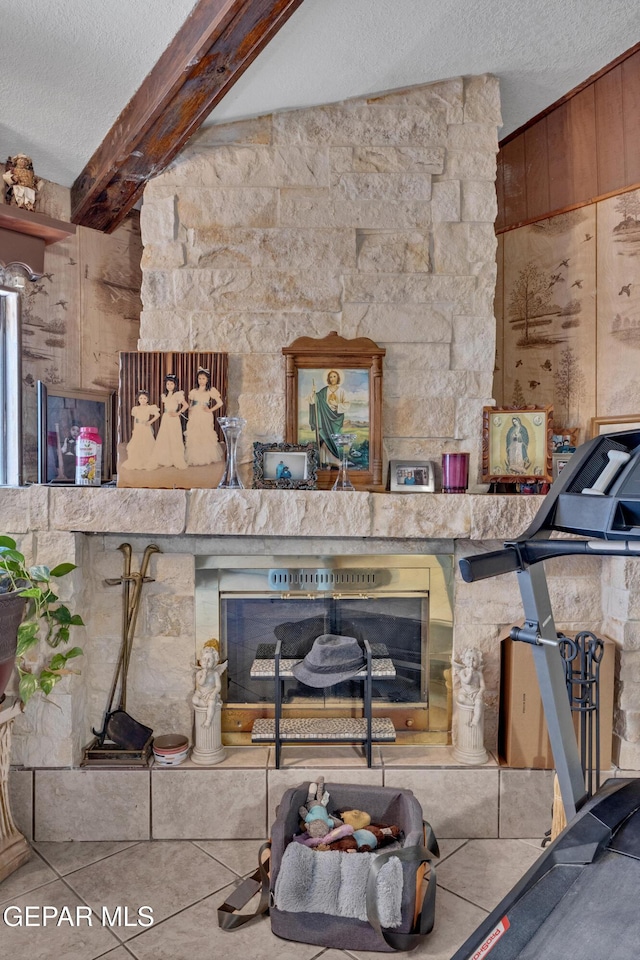 11749 Socorro Rd, Socorro, TX 79927 - living room with a textured ceiling, wooden walls, beam ceiling, and a stone fireplace