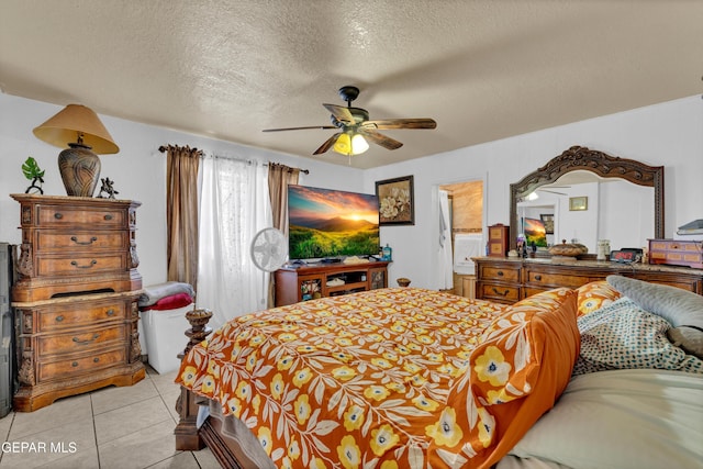 11749 Socorro Rd, Socorro, TX 79927 - bedroom featuring a textured ceiling, light tile patterned floors, a ceiling fan, and ensuite bath
