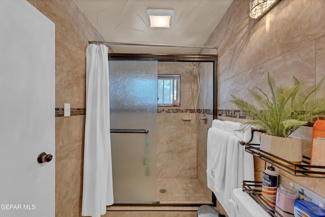 11749 Socorro Rd, Socorro, TX 79927 - bathroom featuring a stall shower and tile walls
