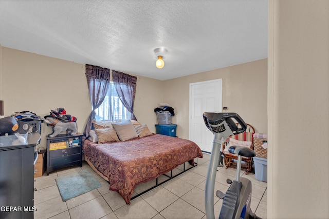 11749 Socorro Rd, Socorro, TX 79927 - bedroom with a textured ceiling and light tile patterned floors