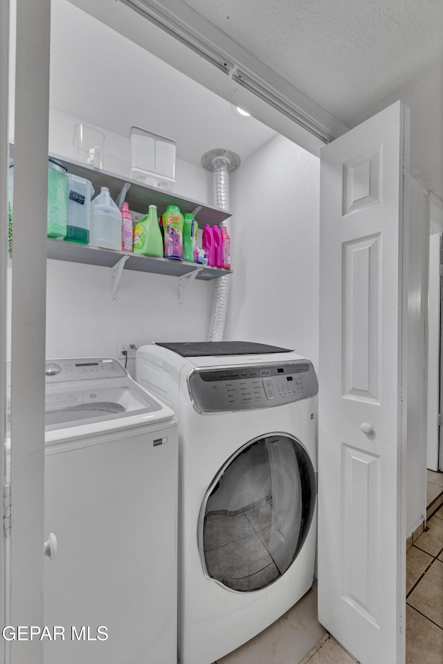 11749 Socorro Rd, Socorro, TX 79927 - laundry room featuring independent washer and dryer, light tile patterned flooring, and a textured ceiling