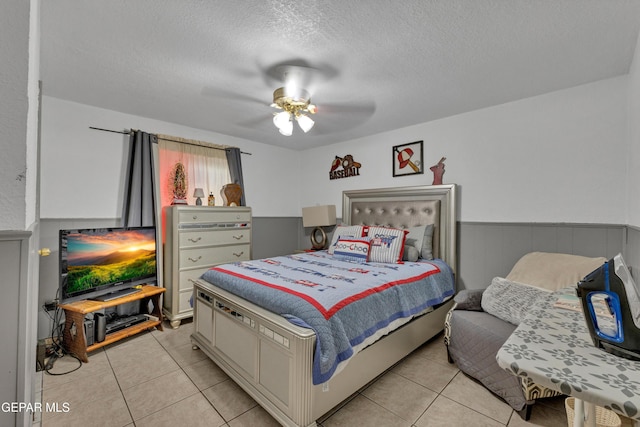 11749 Socorro Rd, Socorro, TX 79927 - bedroom featuring light tile patterned floors, a textured ceiling, and ceiling fan