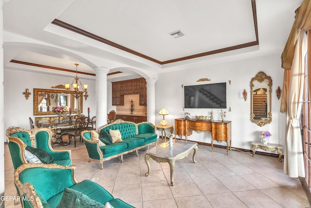 41 Sun Point Ln, El Paso, TX 79912 - living room with a raised ceiling, ornate columns, a chandelier, tile patterned flooring, and ornamental molding