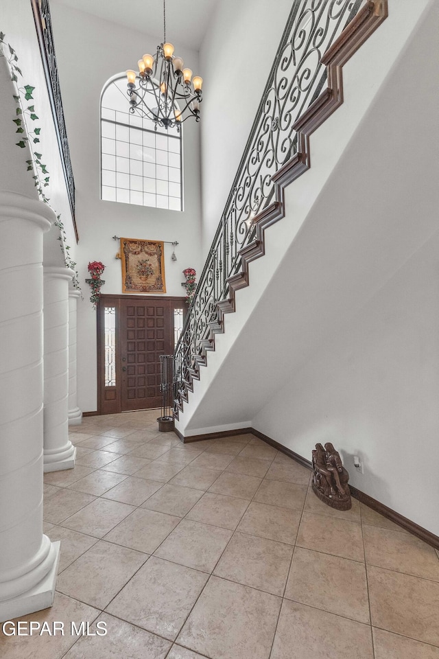 41 Sun Point Ln, El Paso, TX 79912 - entrance foyer featuring tile patterned flooring, a high ceiling, a chandelier, and stairway
