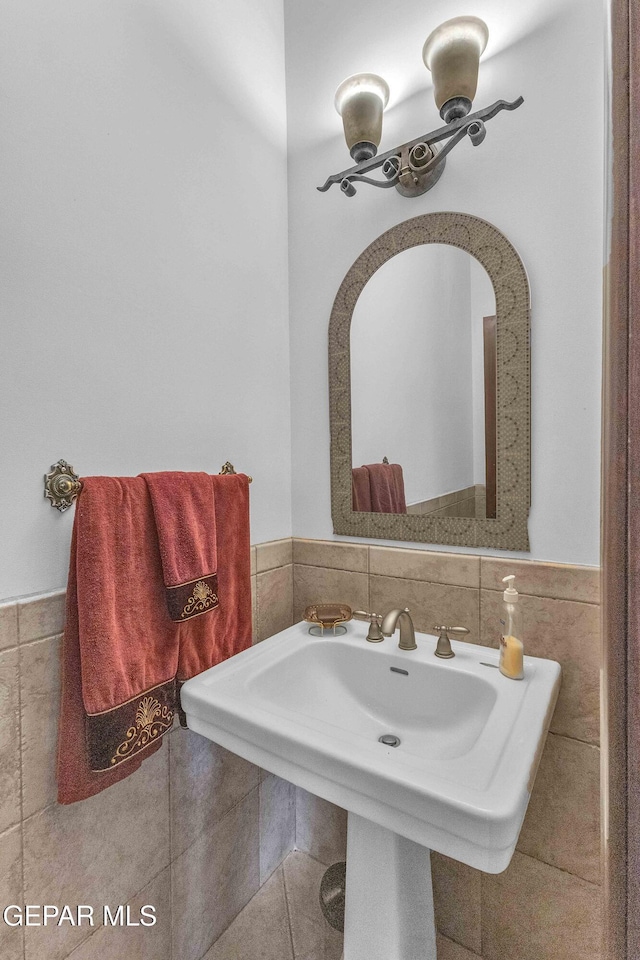 41 Sun Point Ln, El Paso, TX 79912 - bathroom with tile walls, a wainscoted wall, and tile patterned floors