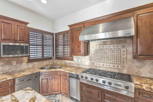 41 Sun Point Ln, El Paso, TX 79912 - kitchen featuring exhaust hood, appliances with stainless steel finishes, decorative backsplash, and light stone countertops
